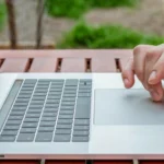 Personne sur son laptop sélectionnant un logiciel